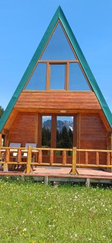 a large wooden house with a large window at Etno SELO Uskoci in Uskoci
