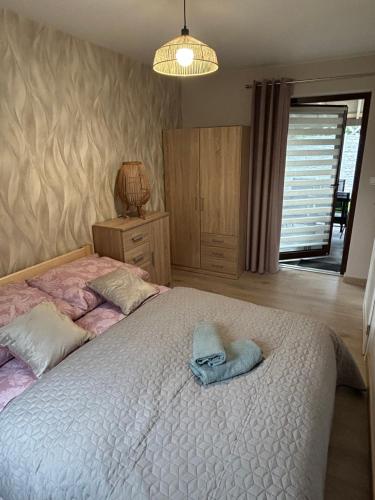 a bedroom with a bed with two towels on it at Domowe Zacisze in Augustów