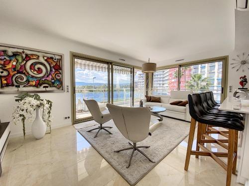 un salon avec une table et des chaises dans l'établissement Bright 2-Bedroom apartment with terrace & parking, à Cannes