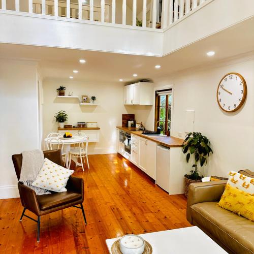 a kitchen and living room with a couch and a table at Aldgate Creek Cottage in Aldgate