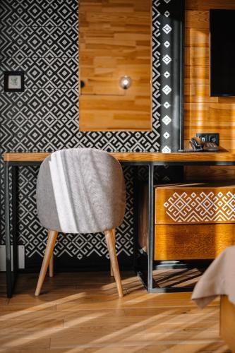 a desk with a chair in a room at RUTA resort Polianytsia ALL INLCUSIVE in Bukovel