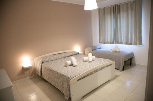 a bedroom with two beds and a window at Sweet House Taormina in Taormina