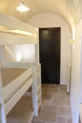 a room with a bunk bed and a door at Trulli Gemma in Antonelli