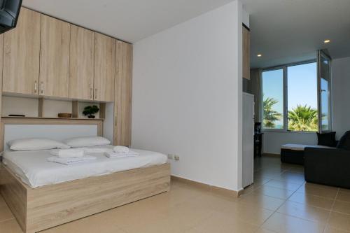 a bedroom with a bed and a living room at Roses Apartment in Golem