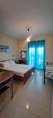 a large bedroom with a large bed and a television at Golden Sun Apartments in Rovies
