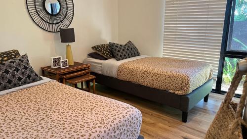 a bedroom with two beds and a window at Coastal Drift - Iluka -Apartment 2 - No Pets Allowed in Iluka