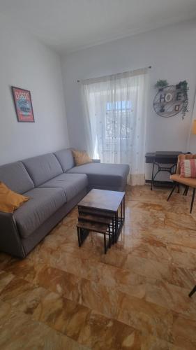 a living room with a couch and a coffee table at Wildflowers House - JApartments in Genova