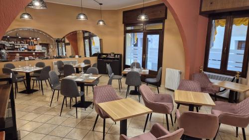 a restaurant dining room with tables and chairs at La Belle Epoque in Aosta