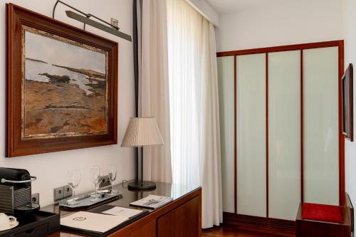 an office with a desk and a picture on the wall at Mirador de Dalt Vila-Relais & Chateaux in Ibiza Town