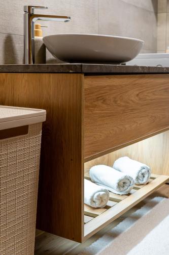 a bathroom with a sink and a counter with towels at Apartment Vila Jela in Kolašin