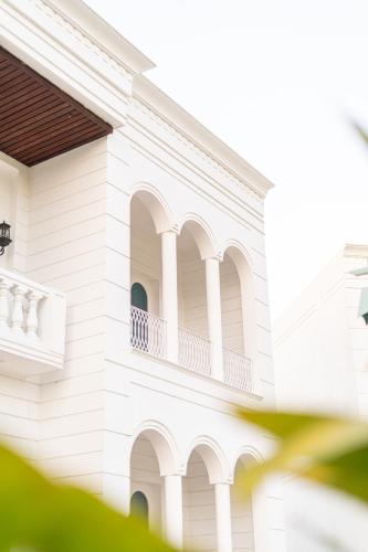 a white house with a balcony on it at Ametsa in Amritsar