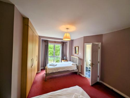 a bedroom with two beds and a window at Large 4 Bedroom 5 Bathroom Property in Galway