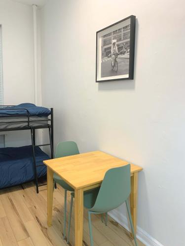 a table and chairs in a room with a bed at Chelsea Studio-Shared Bathroom with Kitchen Twin Bunk Bed in New York