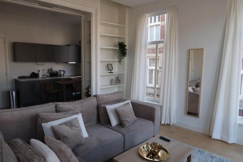 a living room with a couch and a table at Appartement Rokin in Amsterdam