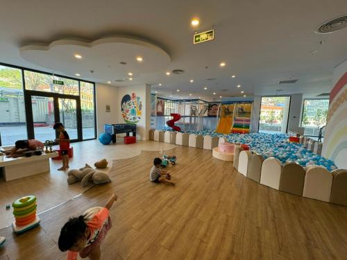 a room with children playing on the floor in a play room at Căn hộ studio 38m2 The Sapphire S2-0802 in Ha Long