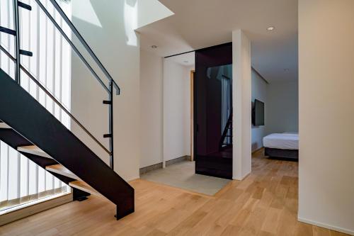 a room with a staircase leading to a bedroom at オーシャンヴィラ館山 in Tateyama