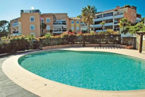 une grande piscine devant un immeuble dans l'établissement Appartement Carqueiranne Vue mer, à Carqueiranne