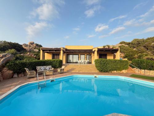 a swimming pool in front of a house at Villa Blue Horizon in Costa Paradiso