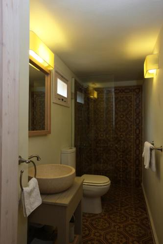 a bathroom with a sink and a toilet and a shower at Dar Alma in Soûr