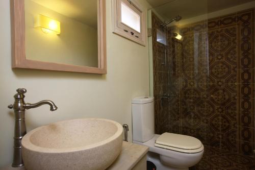 a bathroom with a sink and a toilet and a shower at Dar Alma in Soûr