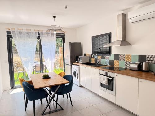 une cuisine avec une table et des chaises dans une cuisine dans l'établissement Maison avec piscine privative au coeur d'une oliveraie, à Roquevaire
