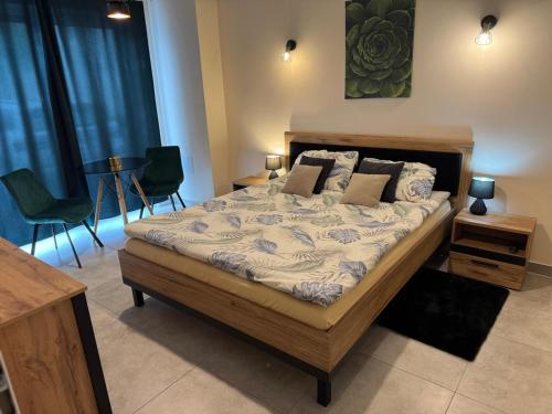 a bedroom with a bed with chairs and a table at The Peaceful Patio Apartment in Rzeszów