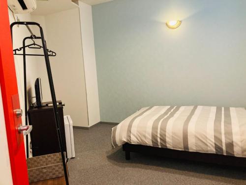 a bedroom with a bed and a tv in it at HOTEL LEOLA - Vacation STAY 25772v in Osaka