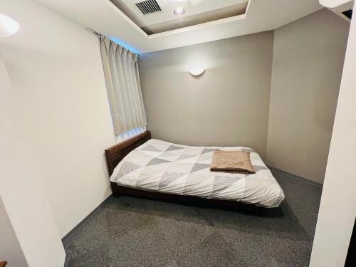 a small bedroom with a bed in a room at HOTEL LEOLA - Vacation STAY 25772v in Osaka