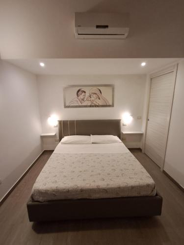 a bedroom with a bed and a painting on the wall at Villa Vera Tropea - free parking in Tropea