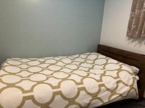 a bed in a bedroom with a bedspread on it at HOTEL LEOLA - Vacation STAY 25772v in Osaka