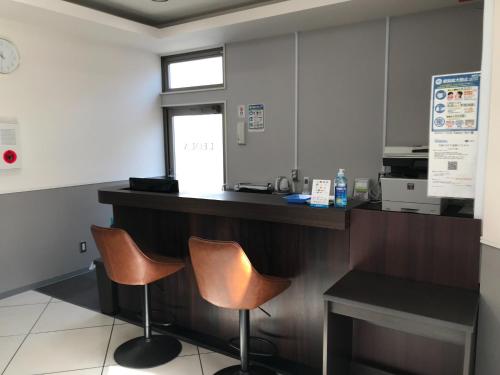 a waiting room with two chairs and a counter at HOTEL LEOLA - Vacation STAY 25772v in Osaka