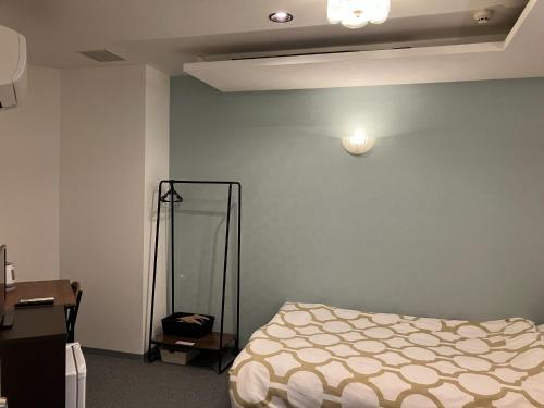 a bedroom with a bed and a blue wall at HOTEL LEOLA - Vacation STAY 25772v in Osaka
