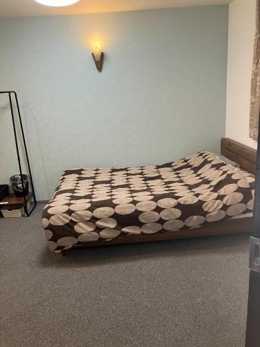 a bed sitting in a room with at HOTEL LEOLA - Vacation STAY 25772v in Osaka