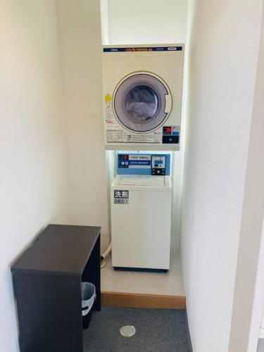 a washer and dryer in a corner of a room at HOTEL LEOLA - Vacation STAY 25801v in Osaka