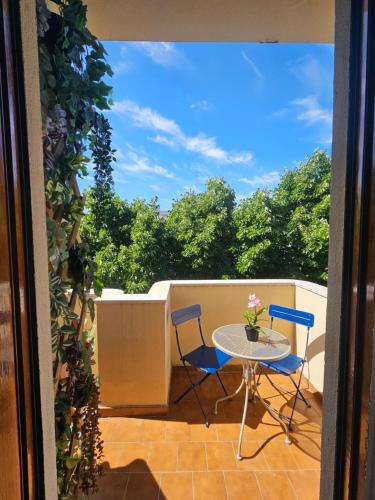 a patio with a table and chairs on a balcony at Mami House Lecce in Lecce