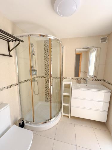 a bathroom with a shower and a tub and a sink at Cortijo Sunny Duplex With Heated Pool & Terrace in Playa de las Americas in Playa de las Americas