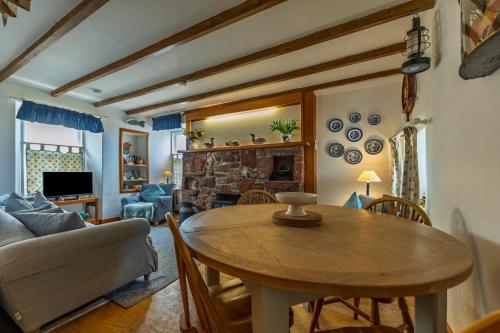 un soggiorno con un tavolo e un divano di Fisherman's Cottage in Pennan a Pennan