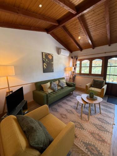 a living room with a couch and a table at A Casa Amarela Guesthouse in São Martinho da Cortiça