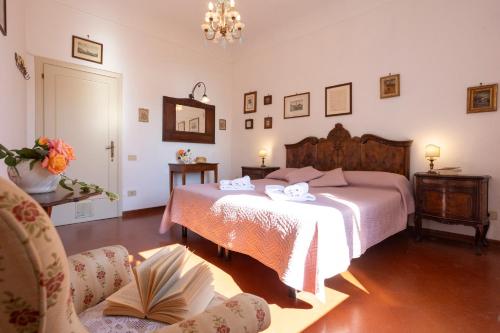 a bedroom with a bed and a chair at Borgo Villa Certano - Case Vacanza in Toscana in Siena