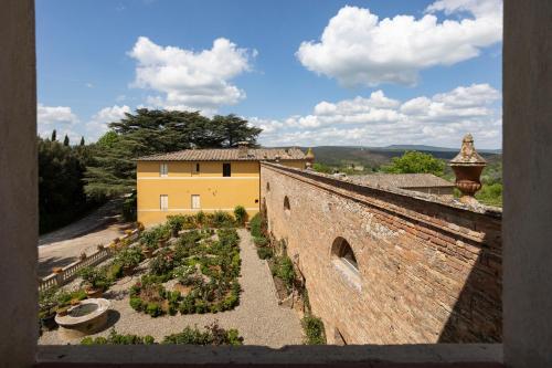 an aerial view of a building and a garden at Borgo Villa Certano - Case Vacanza in Toscana in Siena
