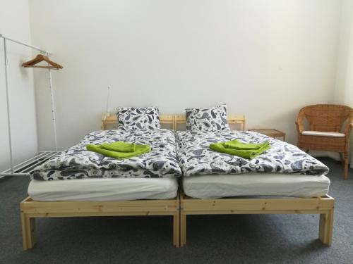 a bed with two green pillows on top of it at Just 3 min Walk Old Town Center private room A in Prague