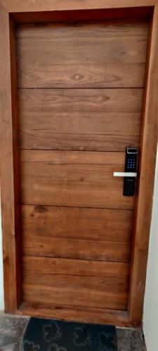 a wooden door with a phone on it at One4ALL SALVIA in Chennai