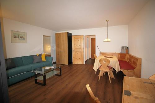 a living room with a couch and a table at Residenza Lagrev 2 Zimmerwohnung Nr 005 - Typ 21A - Hochparterre - Süd in Sils Maria