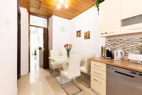 a kitchen and dining room with a table and chairs at Antique Garden Villa in Split