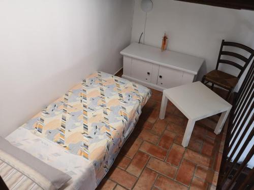 a bedroom with a bed and a chair and a desk at Le mie origini in Bagnoregio