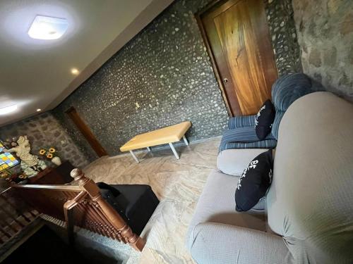 a living room with two couches and a table at CASA HERNANDO Private Resort in Apalit