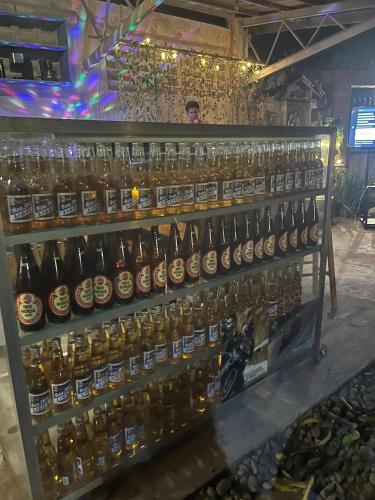a display of beer bottles in a bar at CASA HERNANDO Private Resort in Apalit