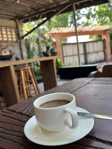 a cup of coffee sitting on a table at CASA HERNANDO Private Resort in Apalit