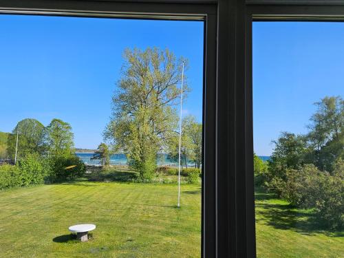 a window view of a yard with a view of the water at Strandvillan i Slite in Slite