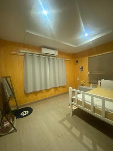 a room with a bed and a sink and a window at Sleep Eat Here at donmuang in Ban Chek